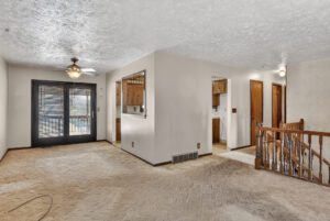 Family room opens to the dining room, with French doors to the covered patio — split-level home in Rockbrook, Omaha NE